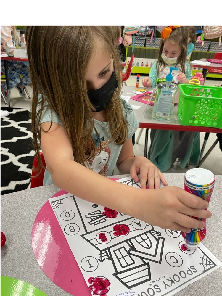 Suzanna Stovall playing a letter bingo haunted house game.