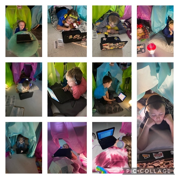 Second grade students reading on camping day 